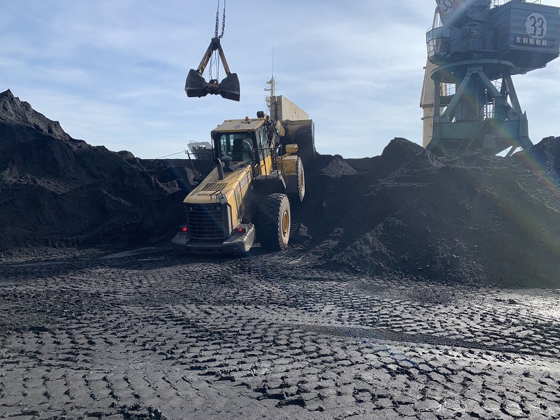 Loader operating between cargo stockpiles